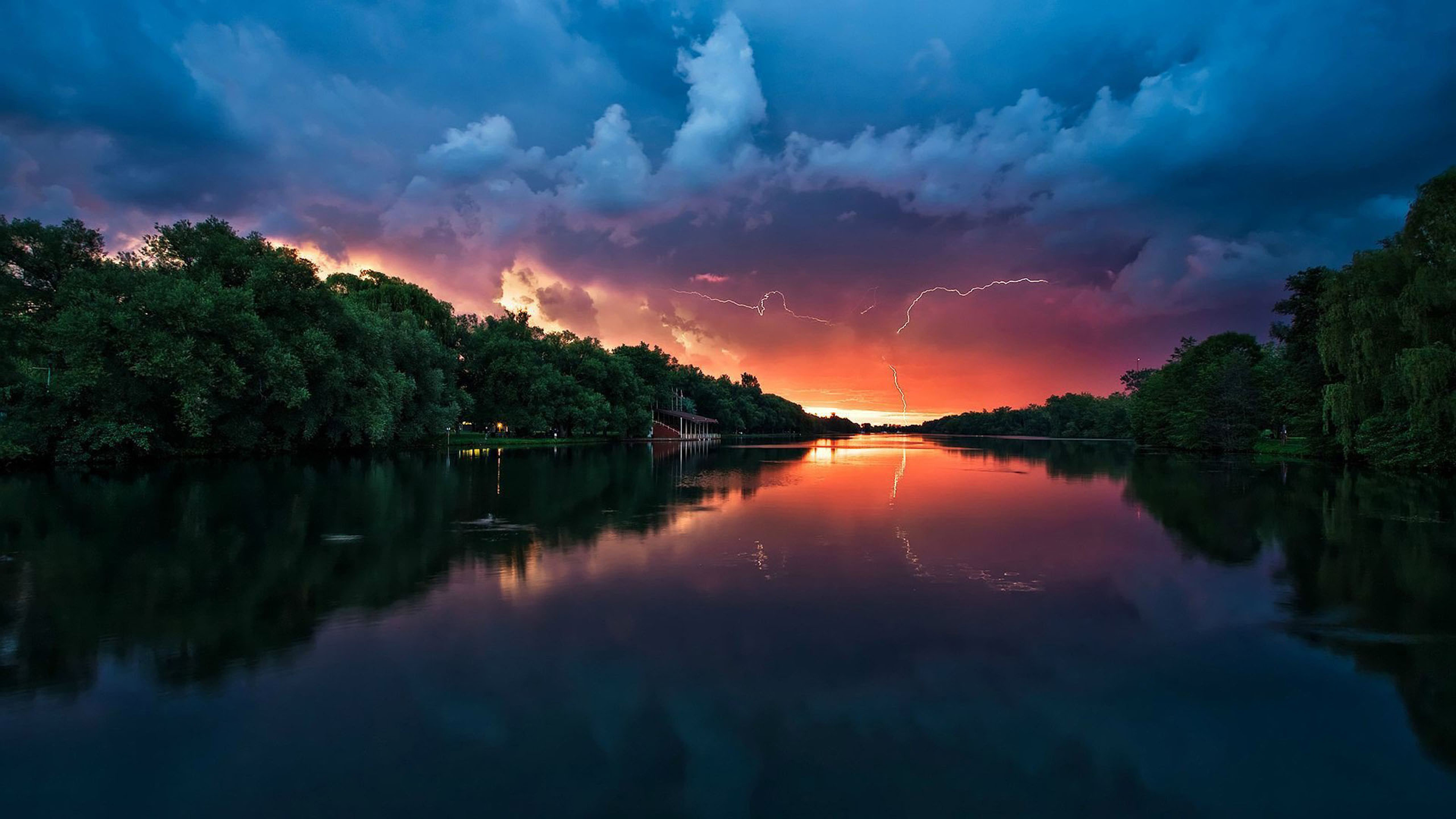 Sunset Peaceful River Coast With Green Trees, Forest Red Sky Lightning